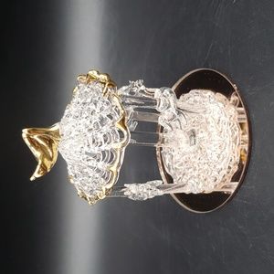 Hand spun glass merry go round on a rose color mirror